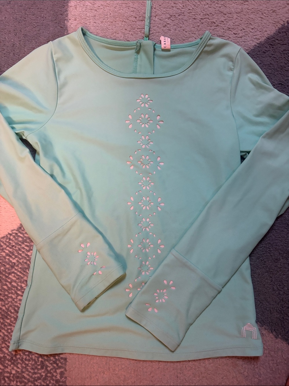 Cabana Life SPF rash guard with Laser Cut Floral Detail.